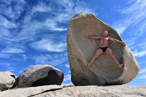 Urso musculoso catalo nas rochas da praia